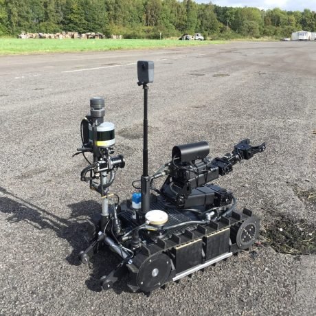 Pictured is a tracked, remote control vehicle being tested as part of the UK Governments Project MINERVA.

A new fleet of robots and drones designed to test for chemical agents, provide 3D mapping and identify casualties have been put through their paces by troops, police officers and scientists for the first time.

Tests of the cutting-edge multi-million-pound project, co-funded by the Ministry of Defence and the Home Office, included robots that can read and climb stairs and miniature drones weighing less than a bar of soap which could soon come into service to rapidly assess hazardous scenes. 

The aim of the ground-breaking research, named Project MINERVA, is to reduce the risk to emergency services and front-line troops attending incidents or operations involving hazardous chemical or biological materials. 

Recent trials, saw concept drones and robots thrown into simulated contaminated scenarios in both UK homeland and battlefield environments. The technology was tested against the speed and accuracy of human response teams supported by specialist Dstl scientists, the military, police and fire services.

Project MINERVA was launched in September 2016 and has been supported by over £3 million in joint funding over 24 months. The project intends to bring the designs from concept to reality in an accelerated timeframe. The recent trials involved the winning concepts for phase 2 of the project.

The project is led by the Defence Science and Technology Laboratory (DSTL). It is funded jointly by the Ministry of Defence science and technology portfolio and the Home Office and contracted through the Defence and Security Accelerator (DASA) with funding from Defence Science and Technology (DST).